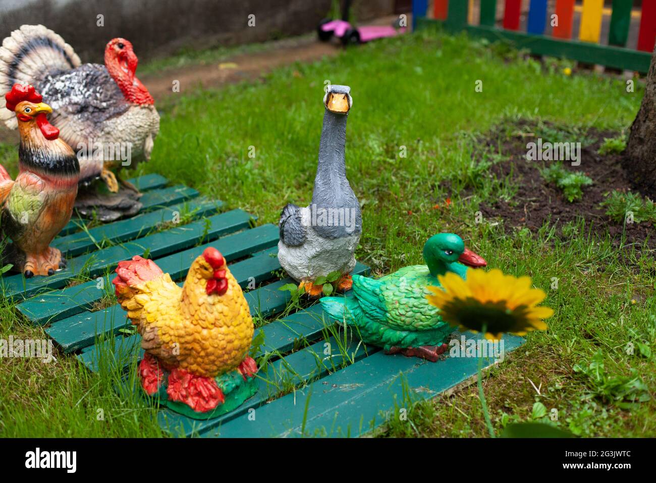 Figures of animals on the lawn. Figurines for flower bed decoration