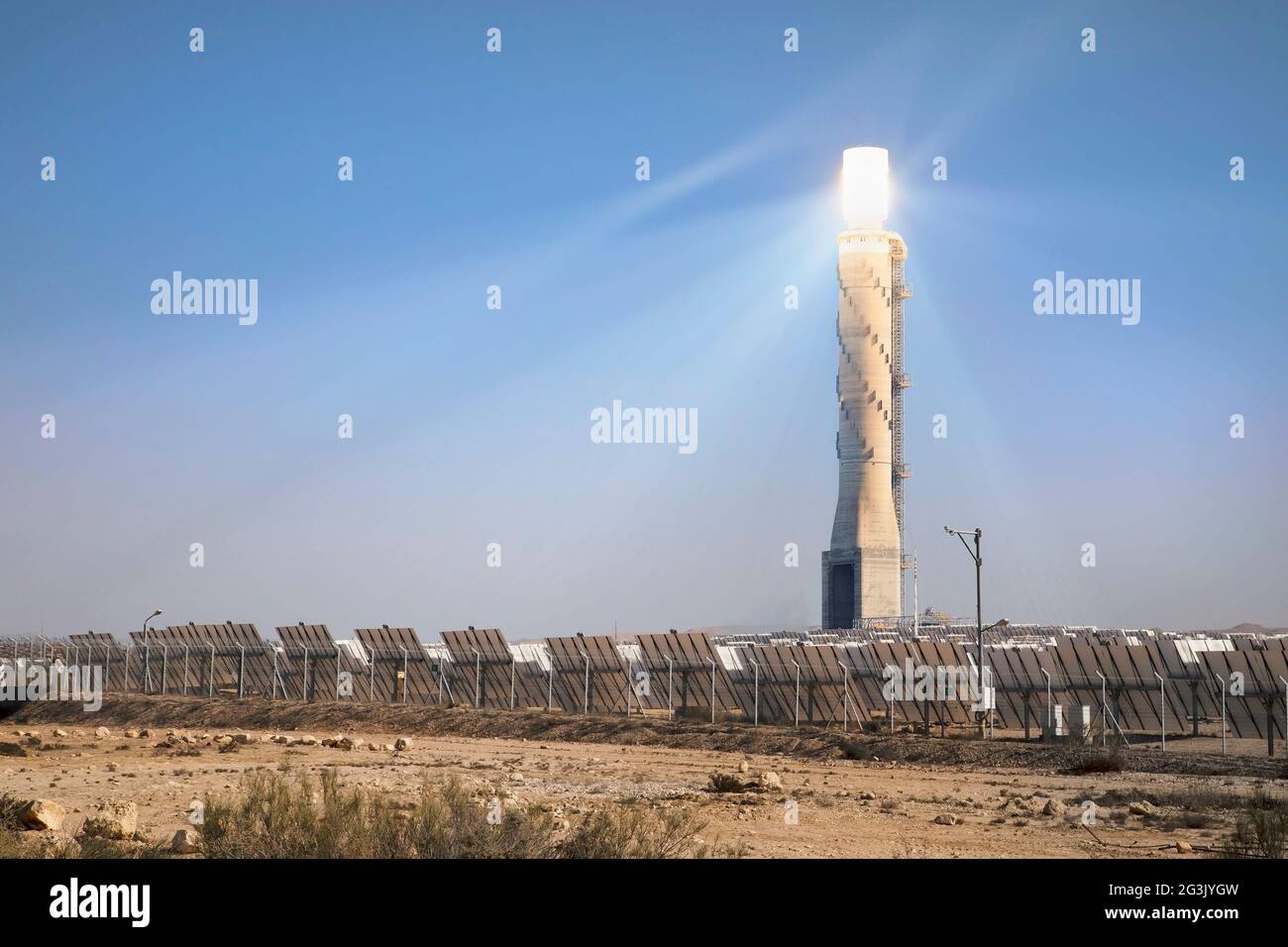 Ashalim solar power station in the Negev desert. Adjustable reflecting mirrors focus the sun's rays onto a boiler at the top of 250m tall solar tower Stock Photo