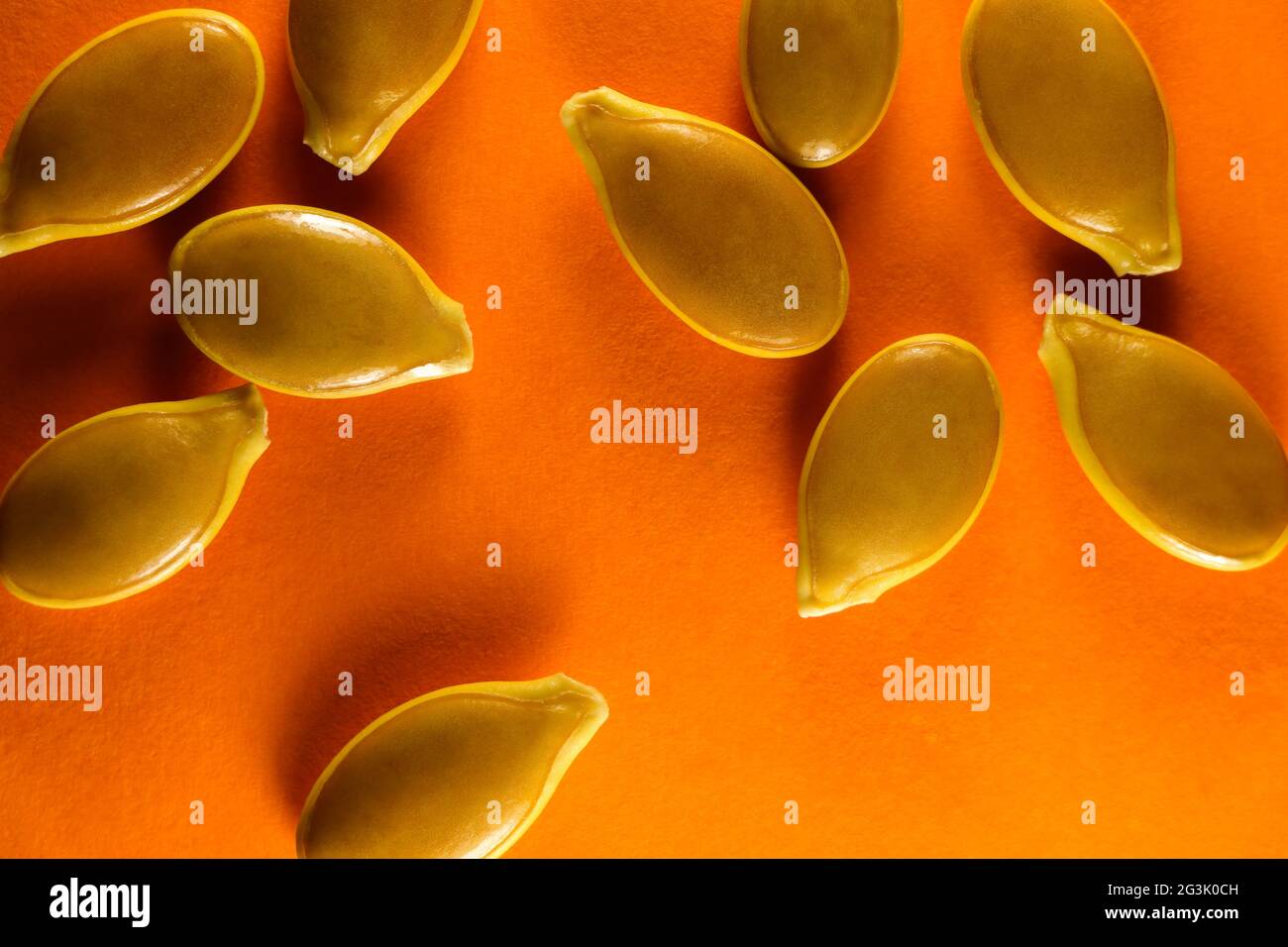 Goliath Pumpkin Seeds Abstract Layout On Orange Stock Photo