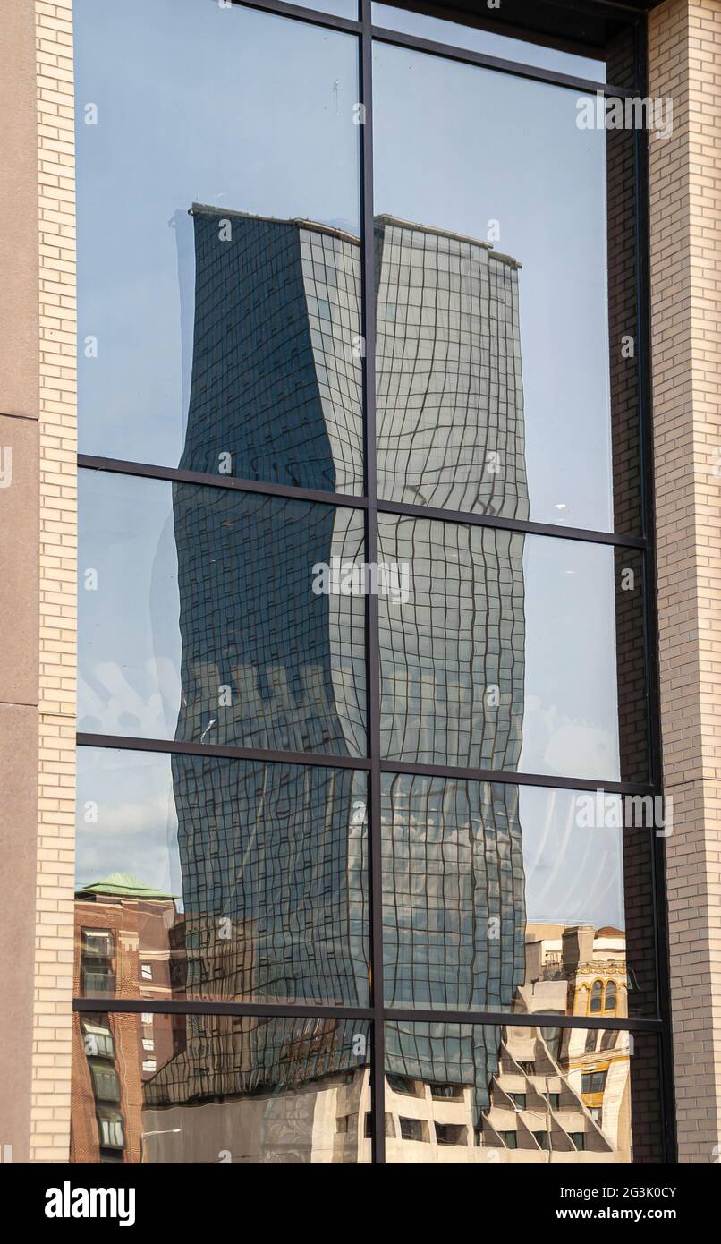 Grand Rapids, MI, USA - June 7, 2008: Closeup of deformed reflection of glass Amway skyscraper in window of Holiday Inn. Stock Photo