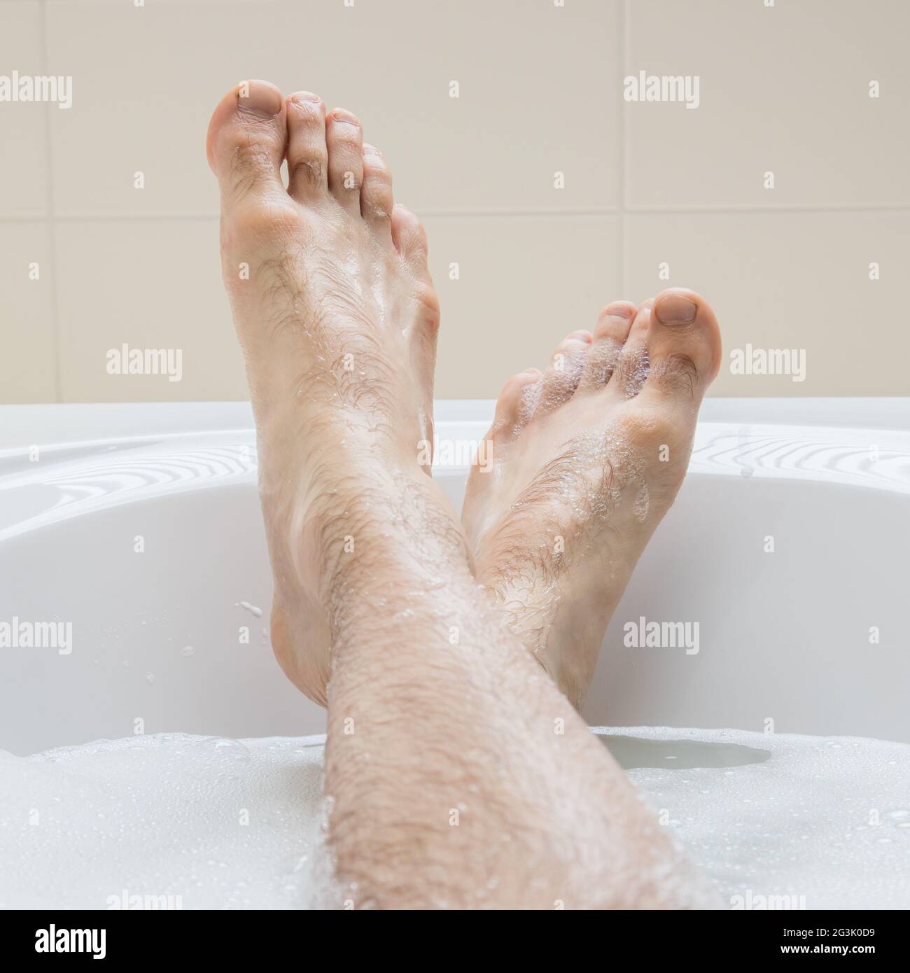 Men's feet in a bathtub, selective focus on toes Stock Photo Alamy