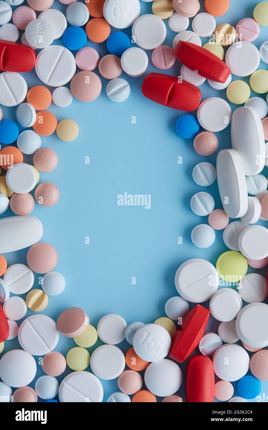 Capsule Frame Frame capsules of different colors and sizes against blue background ...