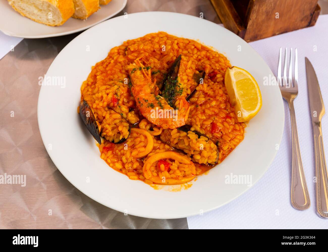 Seafood paella with mussels, calamari rings and prawns Stock Photo
