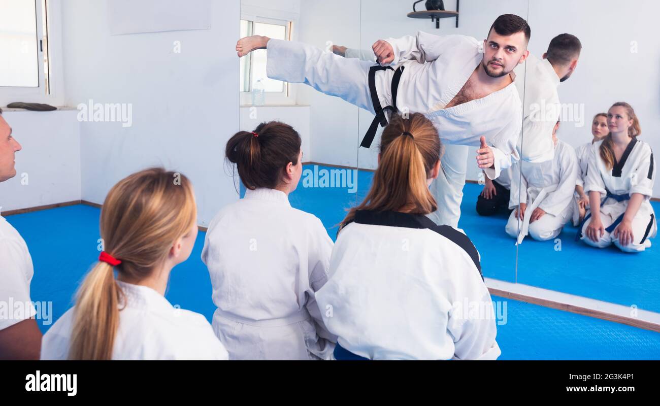 Karate coach teaching adults Stock Photo
