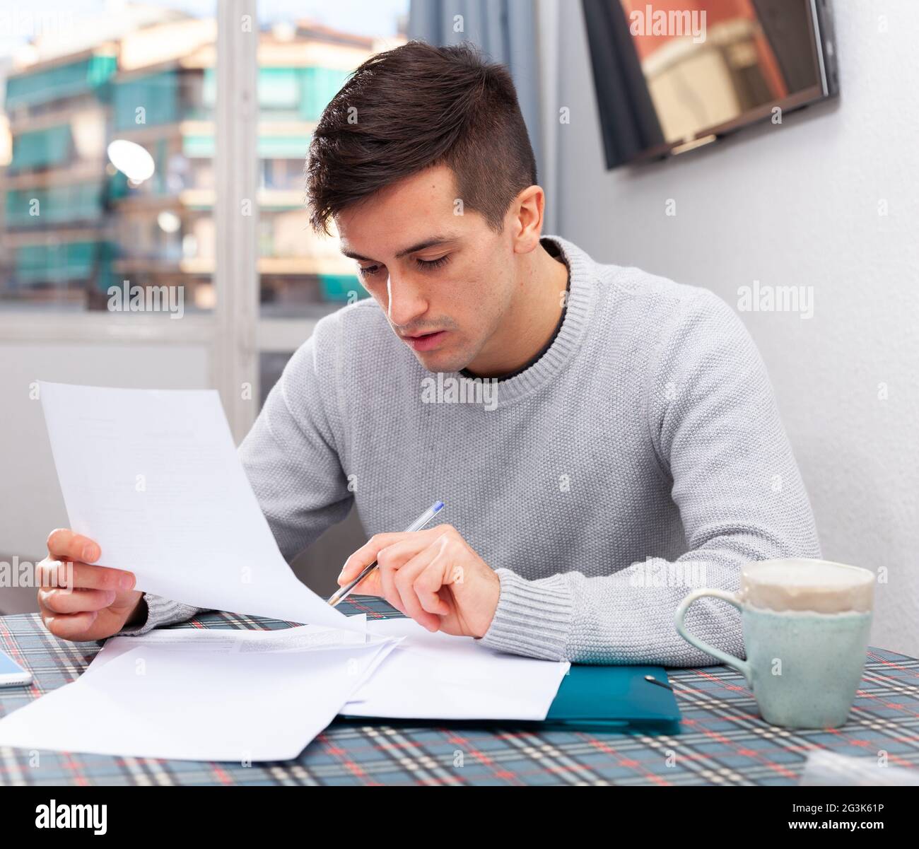 Man looks documents income tax hi-res stock photography and images - Alamy