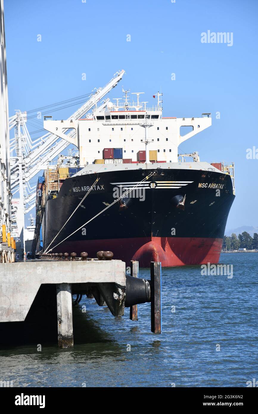 Shipping containers are loaded onto ships at the Port of Oakland