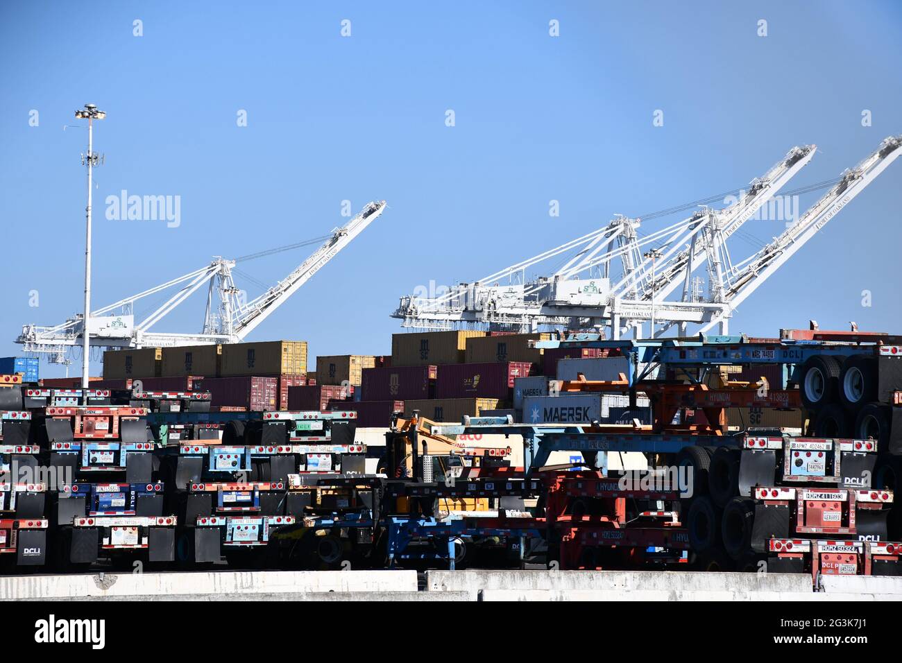 Shipping containers are loaded onto ships at the Port of Oakland