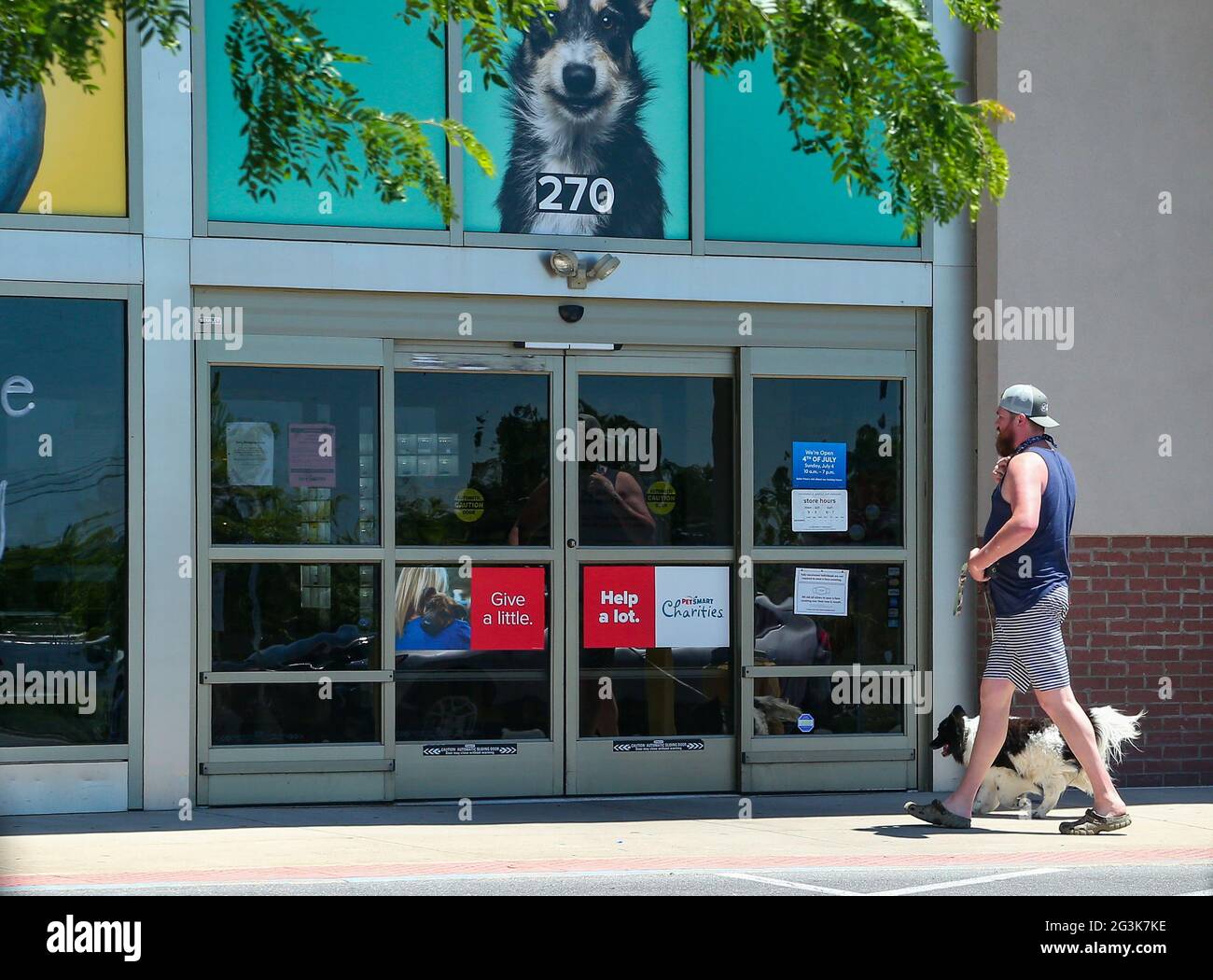A man and a dog are seen at the entrance of a PetSmart store at Monroe