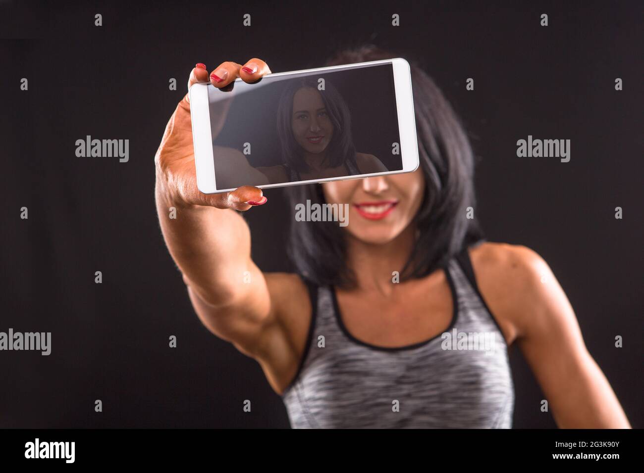 Fitness woman making self photos in studio Stock Photo