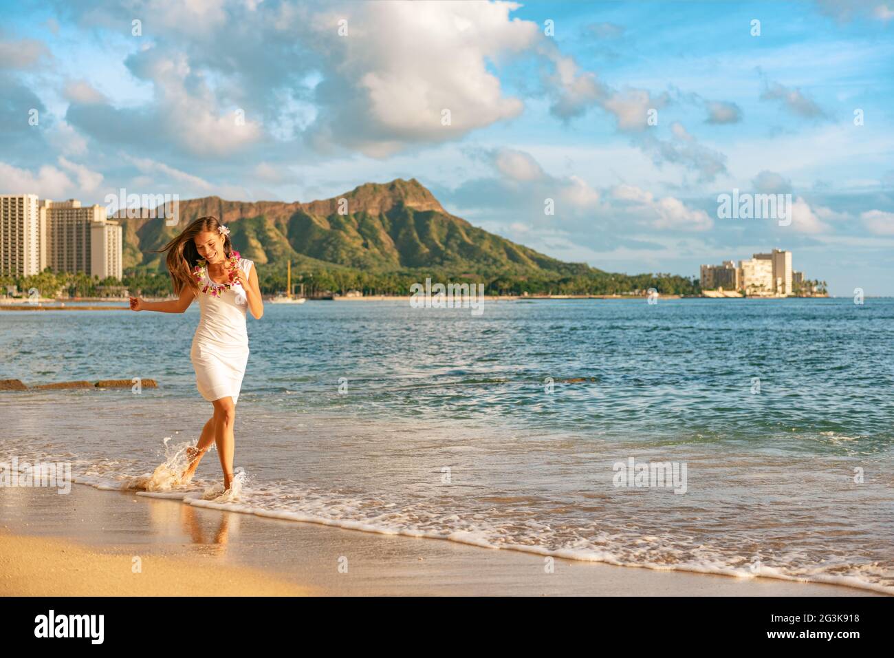 Hawaii vacation woman relaxing on Waikiki beach running carefree