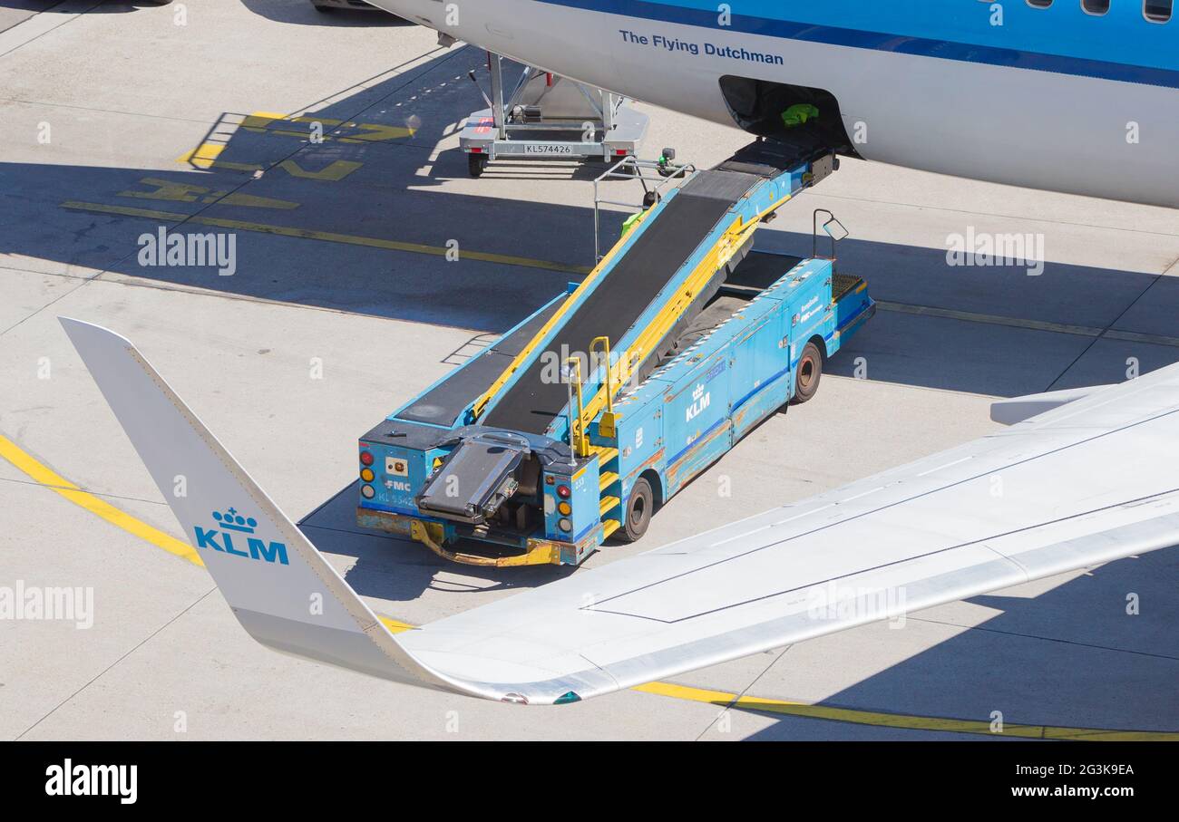 AMSTERDAM, NETHERLANDS - AUGUST 17, 2016: Loading luggage in airplane at Amsterdam Schiphol airport, Netherlands on August 17, 2 Stock Photo