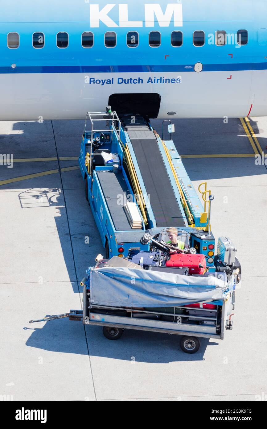 AMSTERDAM, NETHERLANDS - AUGUST 17, 2016: Loading luggage in airplane at Amsterdam Schiphol airport, Netherlands on August 17, 2 Stock Photo