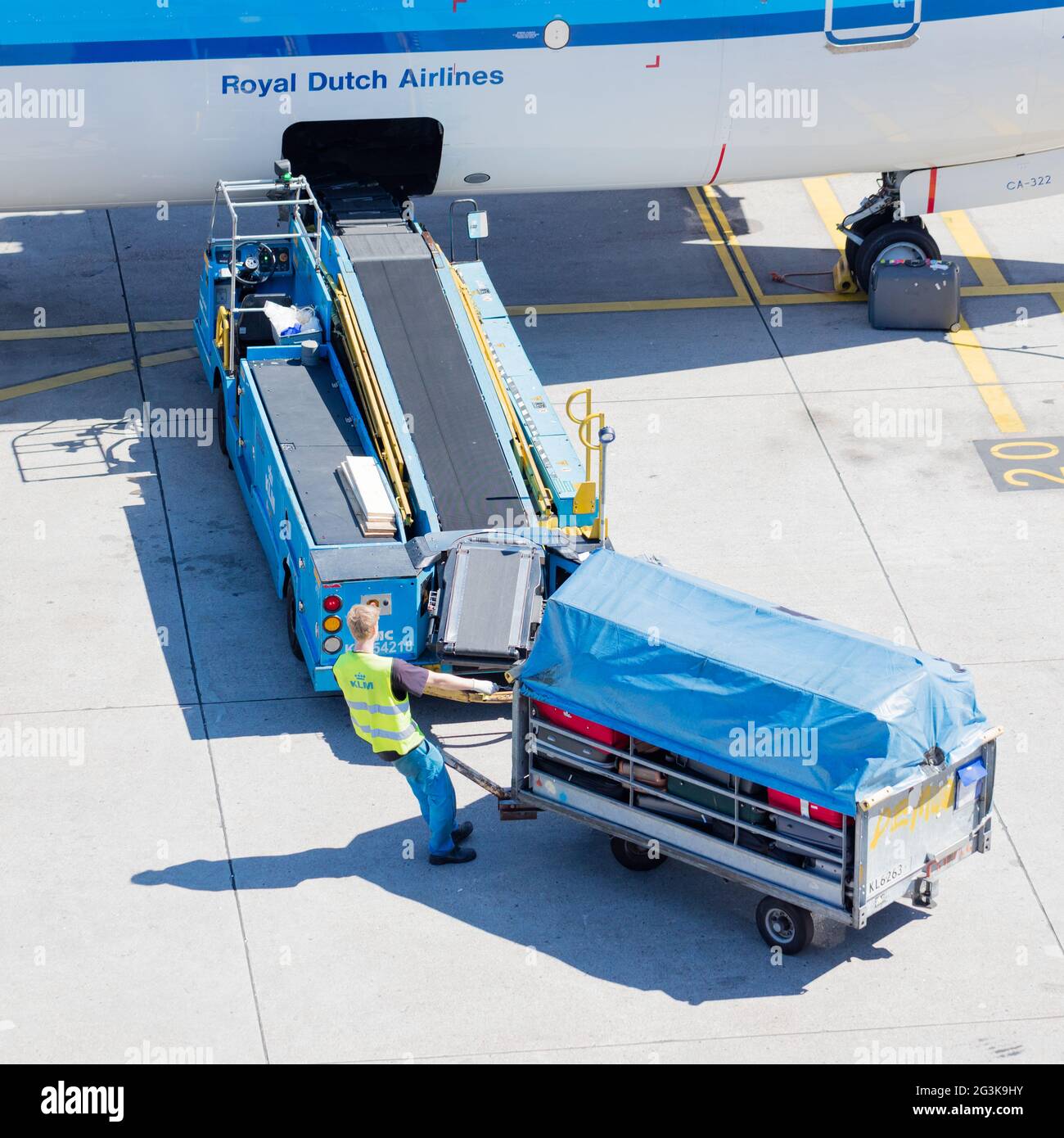 AMSTERDAM, NETHERLANDS - AUGUST 17, 2016: Loading luggage in airplane at Amsterdam Schiphol airport, Netherlands on August 17, 2 Stock Photo