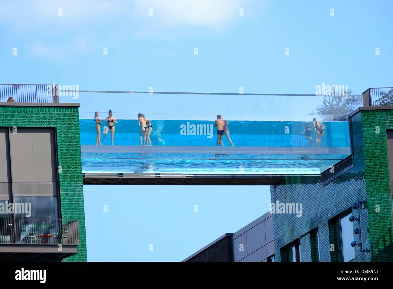 London Uk Swimmers At The Newly Opened Sky Pool At Embassy Gardens Wave To The Camera The Transparent Pool Is Suspended Between Two Buildings Stock Photo Alamy