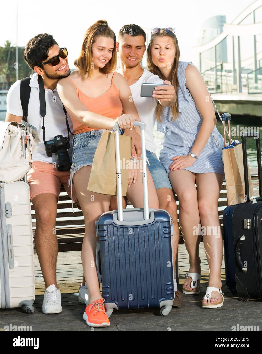 Group of tourists are taking selfies on phone in european town Stock Photo