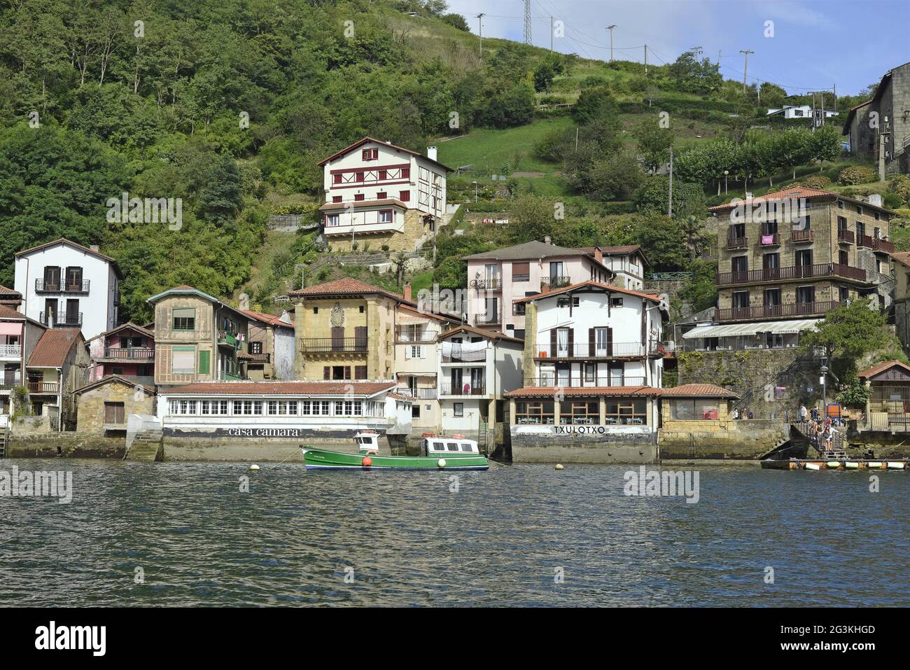 View of the fishing village along with its waterfront and boats in Pasai Donibane, Spain Stock Photo