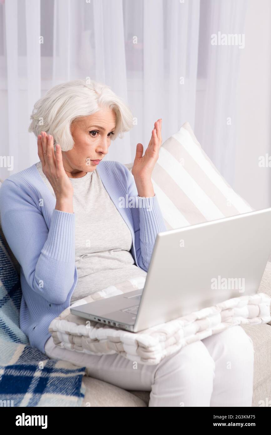 Preppy Grandma Using Computer Grandmother using laptop computer Stock Photo - Alamy