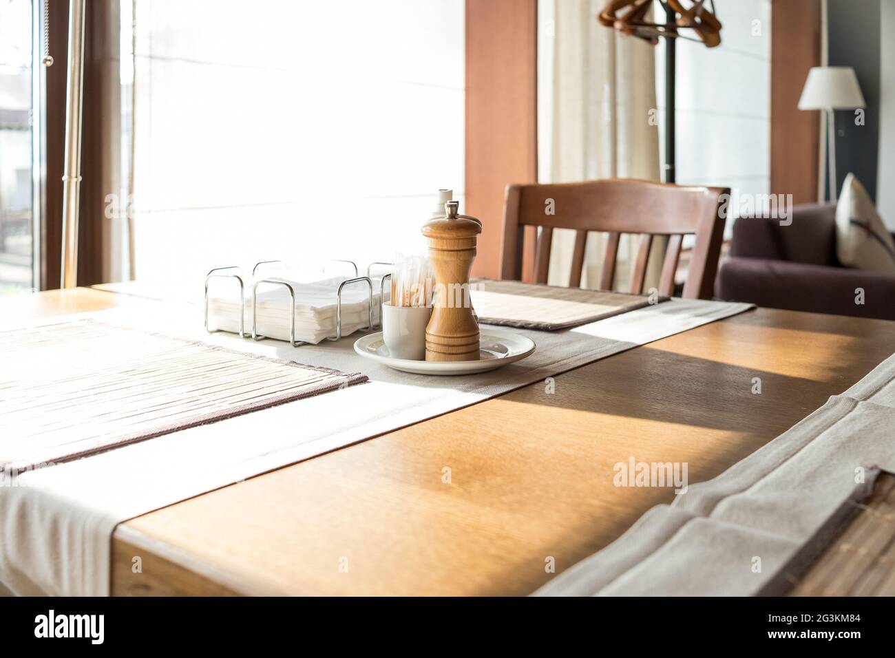 Part of restaurant table setting salt, pepper, toothpicks and paper napkins in wooden box on table Stock Photo