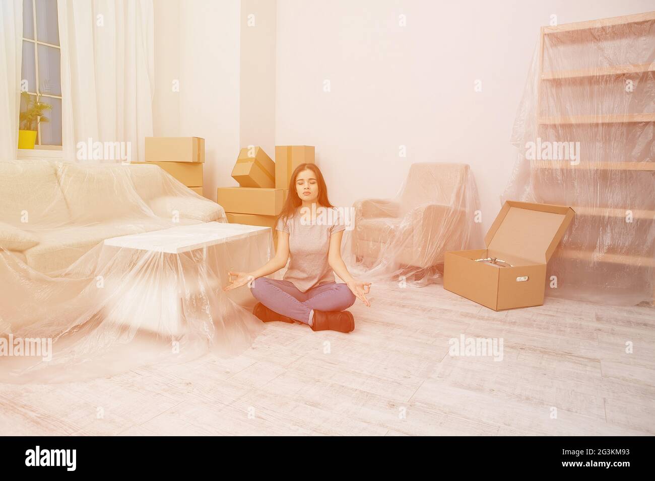 Young girl trying to keep calm and relax during the relocation. Stock Photo