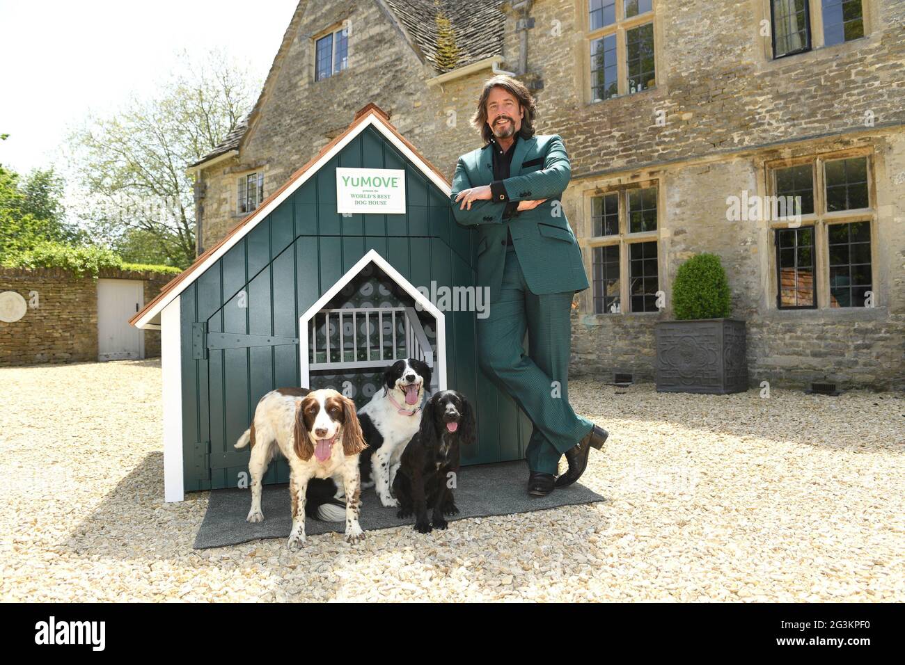EDITORIAL USE ONLY Television personality and interior designer, Laurence Llewelyn-Bowen, alongside his pets, unveils the 'World's Best Dog House', which he has designed in partnership with canine joint supplement brand YuMOVE for a new campaign to encourage dog owners to make simple home improvements that can benefit the long-term health and wellbeing of their pets, Cirencester. Issue date: Thursday June 17, 2021. Stock Photo