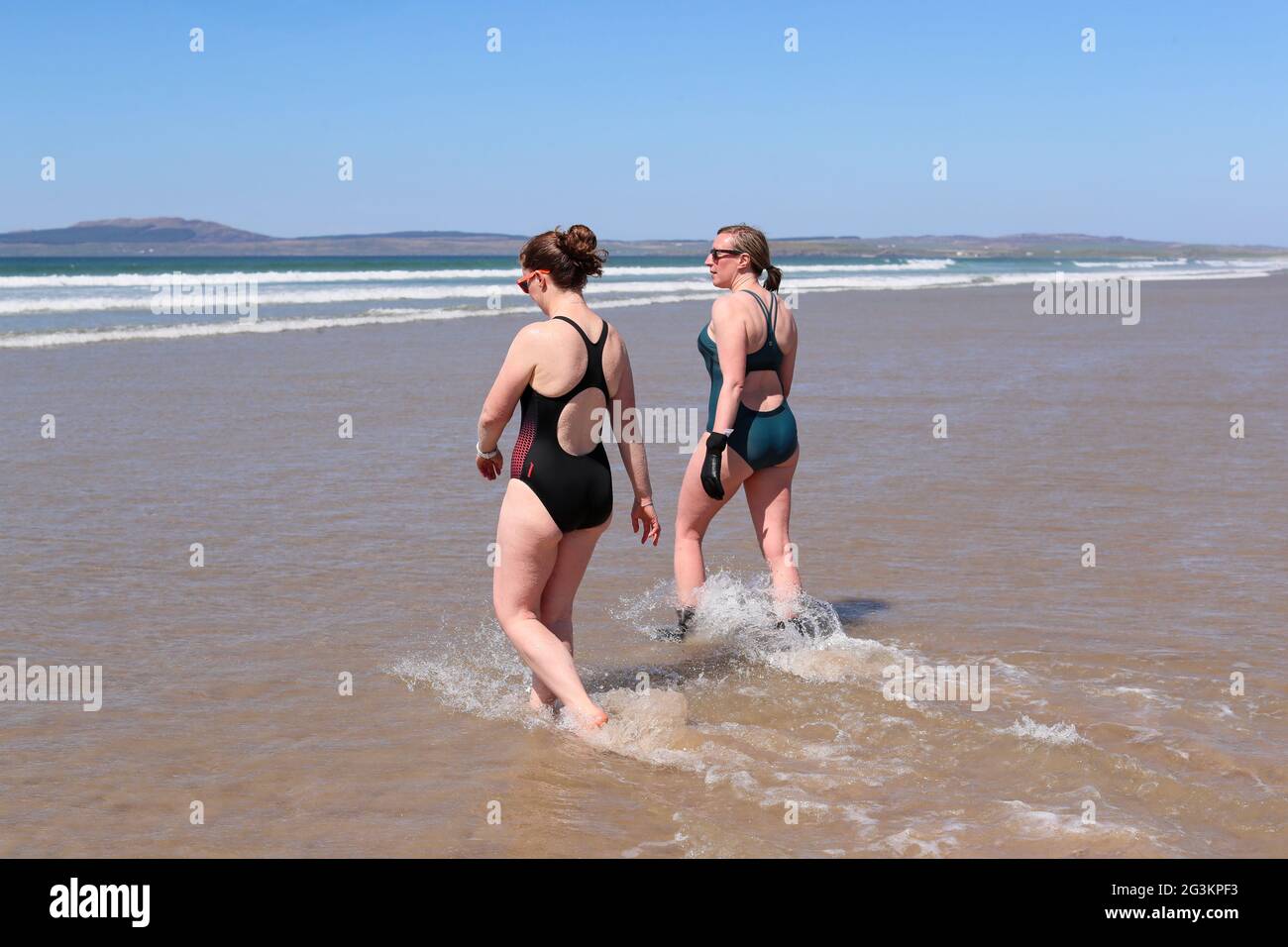 Women take part in open water swimming on the Isle of islay off Scotland's west coast during a staycation. Stock Photo