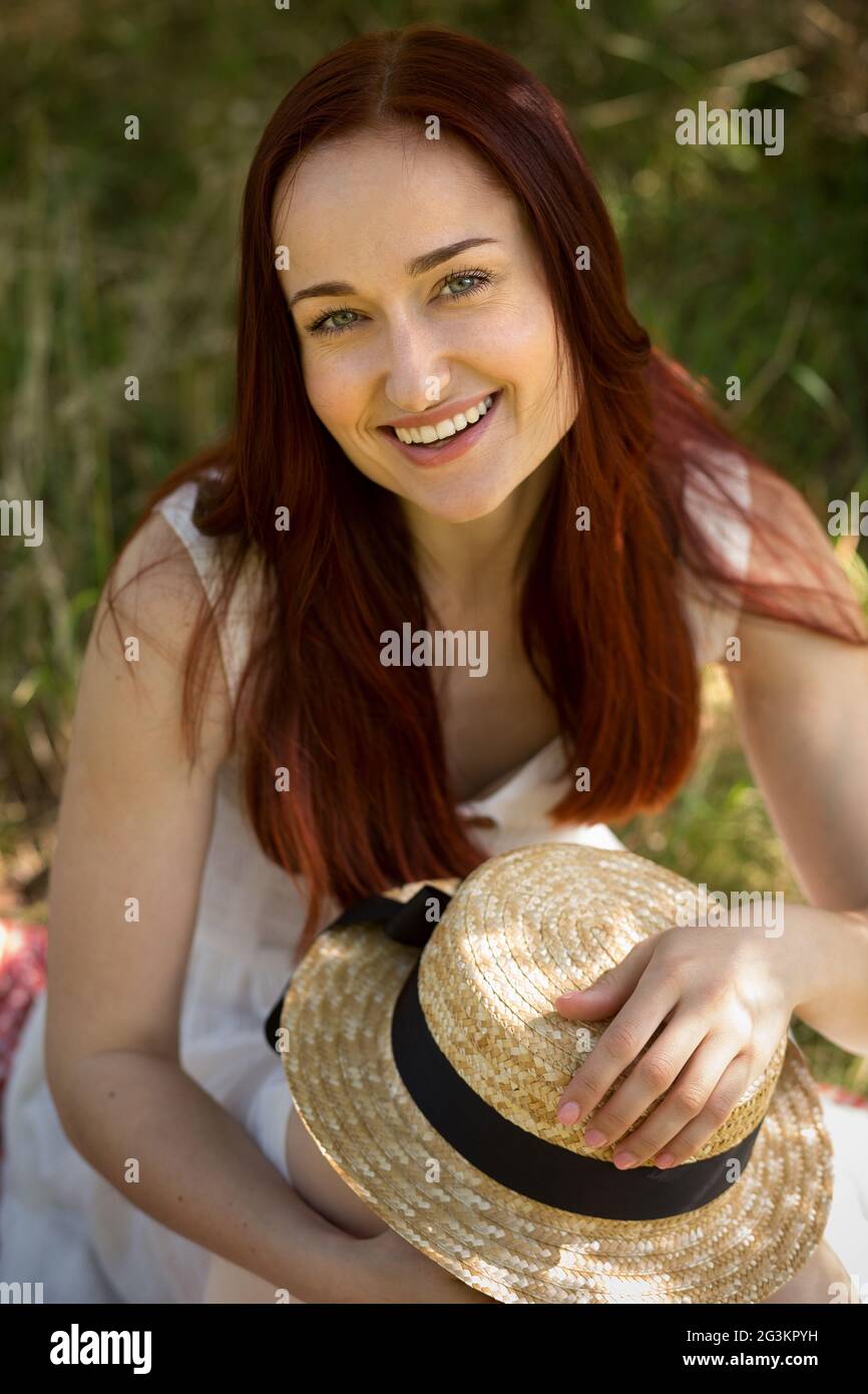 Charming red haired woman enjoying nature outdoors. Stock Photo