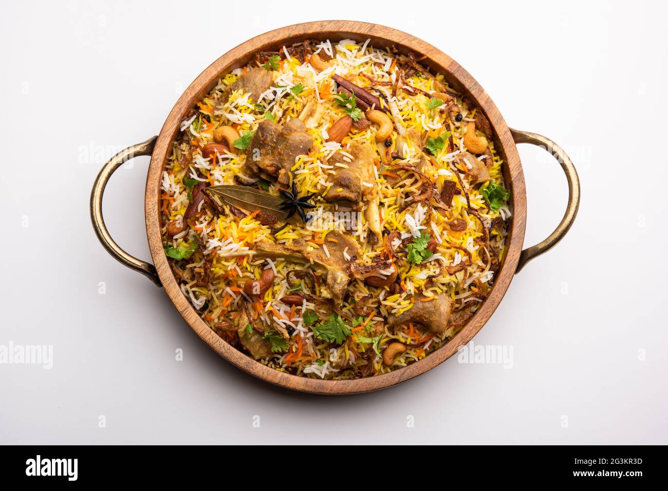 Indian Mutton biryani prepared in Basmati Rice served with Yogurt dip over moody background