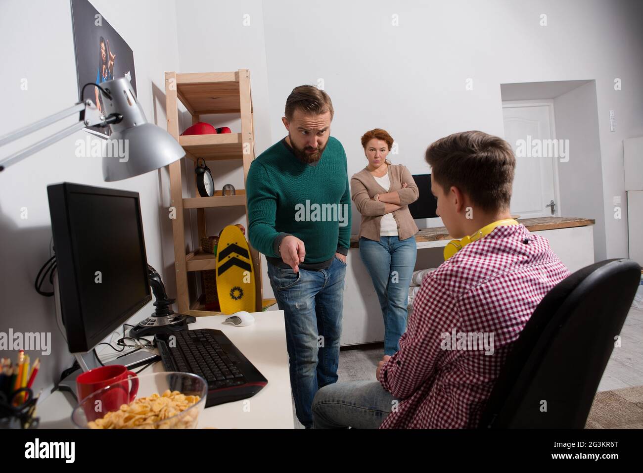 Parents quarreling with teenage son addicted to computer games. Stock Photo