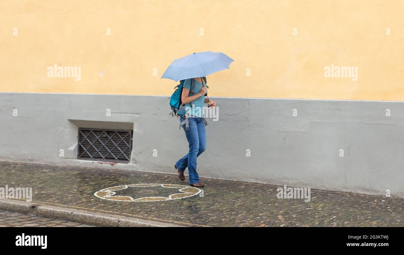 Mysterious girl walking with umbrella Stock Photo - Alamy