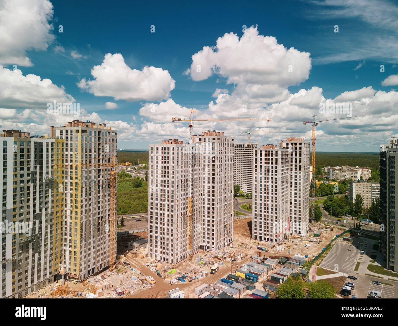 Aerial view on construction site of high rise buildings with cranes, machinery and scaffoldings. Development investment advertising Stock Photo