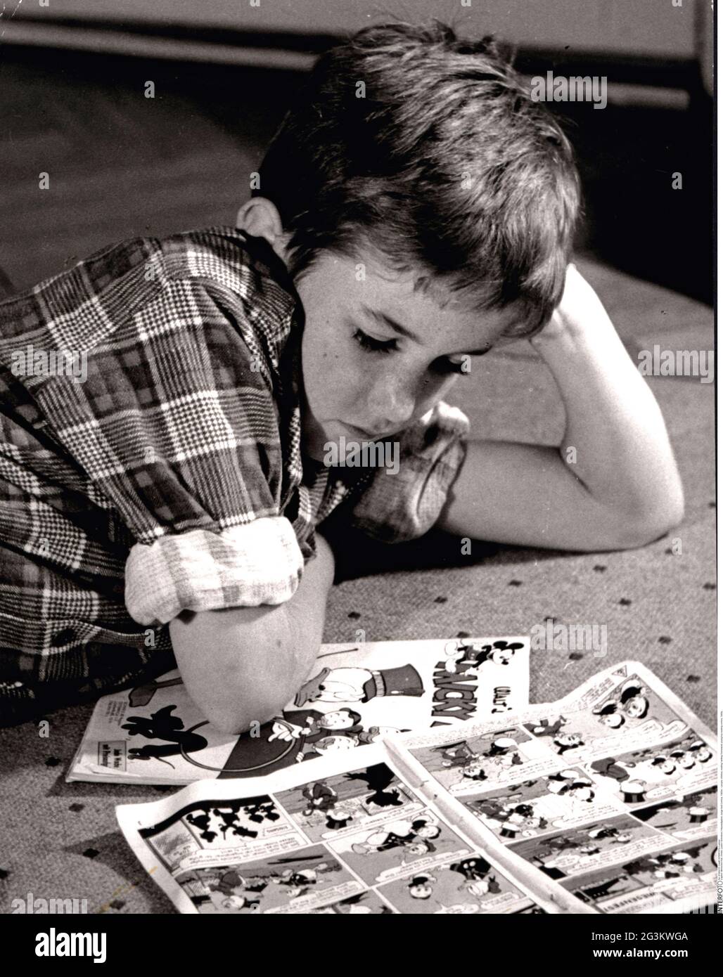 people, children, reading / writing / homework, young boy reading comics, 1960s, ADDITIONAL-RIGHTS-CLEARANCE-INFO-NOT-AVAILABLE Stock Photo