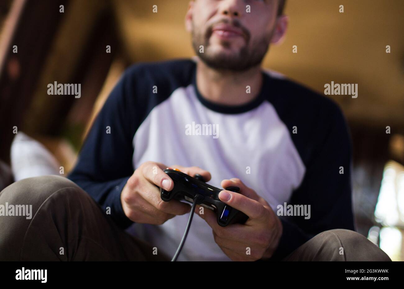 Gamer using controller to play online video games on computer. Man playing  game with joystick and headphones in front of monitor. Player having gaming  equipment, doing fun activity Stock Photo - Alamy