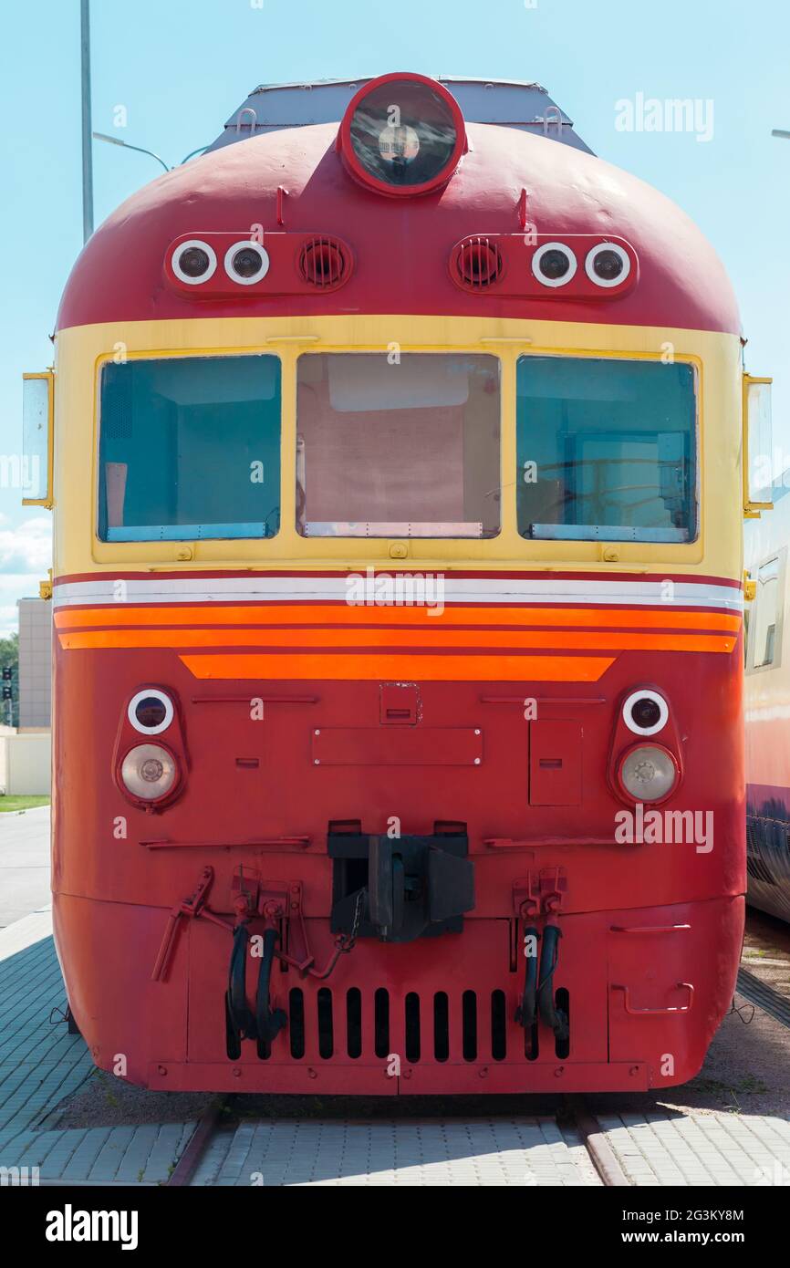 Vintage red diesel locomotive is on a railway on a sunny day, front view Stock Photo