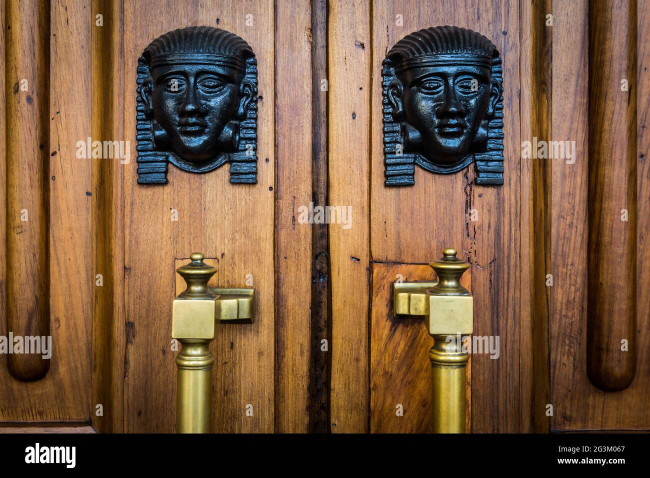 Sphinx heads entrance on wooden door Stock Photo Alamy