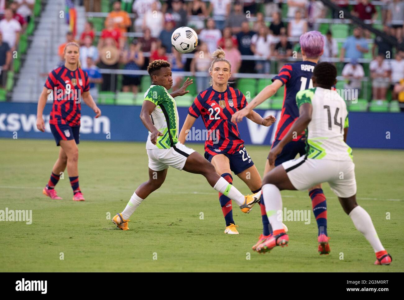 Austin, Texas, USA, June 16 2021: KRISTIE MEWIS (22) of Team USA threads between two Nigerian defenders in the first half as the US Women's National Team (USWNT) beats Nigeria, 2-0 in the inaugural match of Austin's new Q2 Stadium. The U.S. women's team, an Olympic favorite, is wrapping up a series of summer matches to prep for the Tokyo Games. At right is CHIDNMA OKEKE (14) of Nigeria. Credit: Bob Daemmrich/Alamy Live News Stock Photo