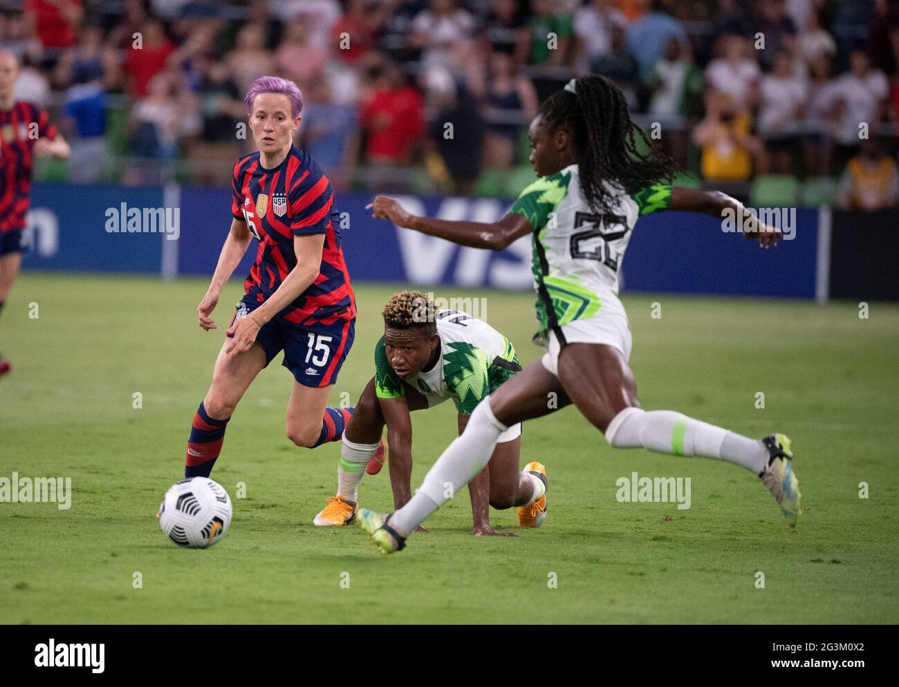 USA forward MEGAN RAPINOE (15) challenges RITA CHIKWELU (10) and MICHELLE ALOZIE (22) of Nigeria during the second half of the US Women's National Team (USWNT) 2-0 victory over Nigeria, in the first match at Austin's Q2 Stadium. The U.S. women's team, an Olympic favorite, is wrapping up a series of summer matches to prep for the Tokyo Games. Press scored a goal in the win for USA Soccer. Credit: Bob Daemmrich/Alamy Live News Stock Photo