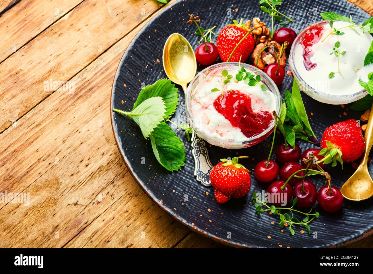 Summer dessert, ice cream with strawberries and cherries.Ice cream with berry jam Stock Photo