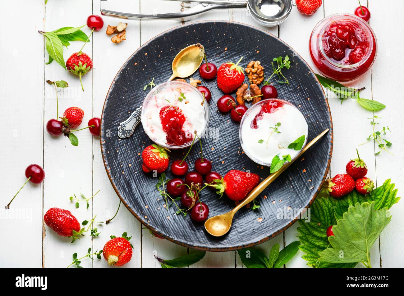 Summer dessert, ice cream with strawberries and cherries.Ice cream with berry jam Stock Photo