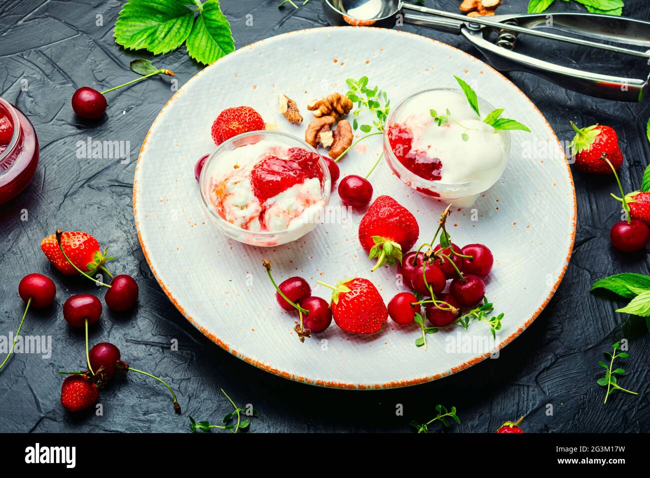 Summer dessert, ice cream with strawberries and cherries.Ice cream with berry jam Stock Photo