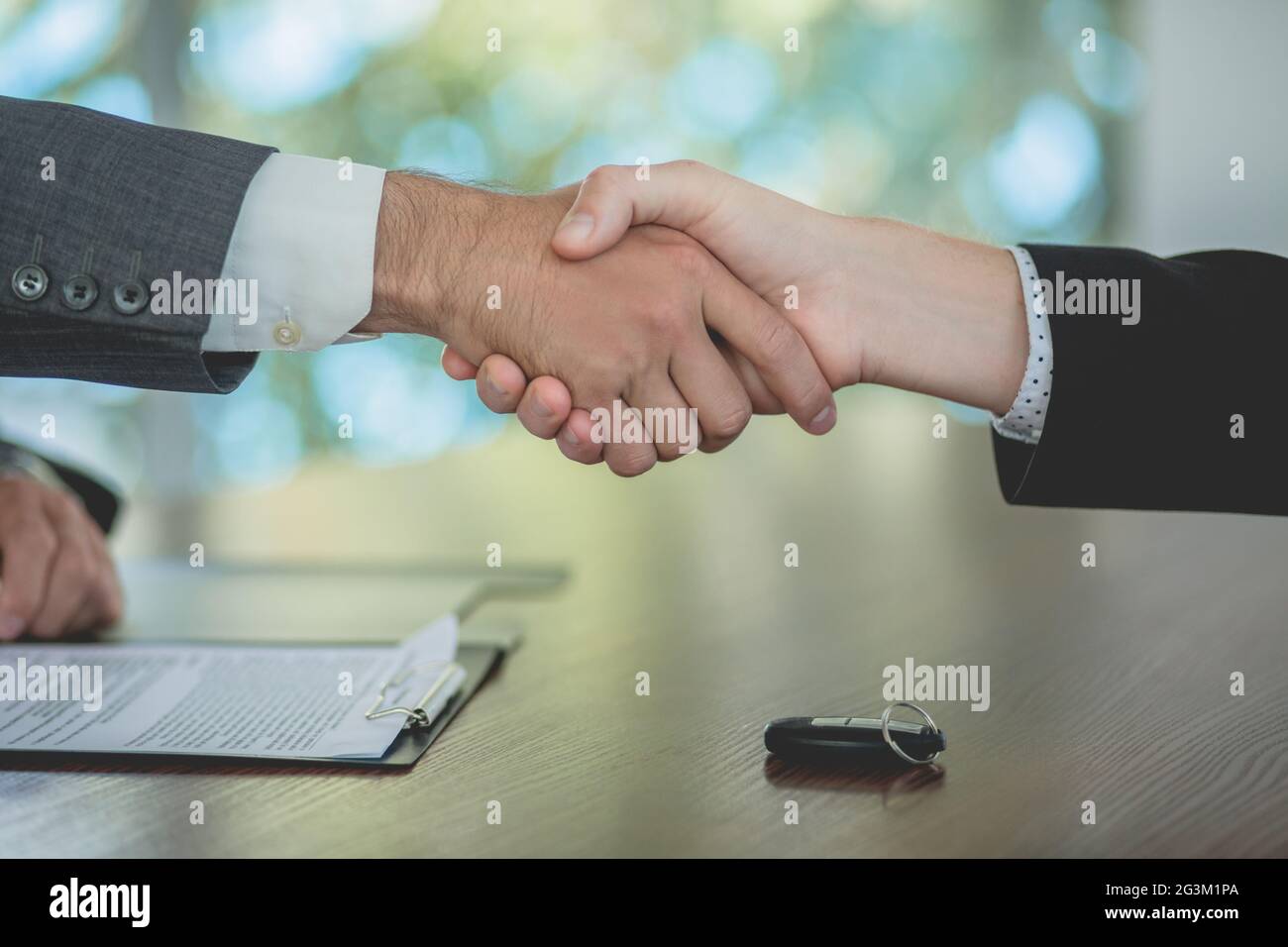 buying-a-car-sales-manager-and-buyer-shakig-hands-stock-photo-alamy