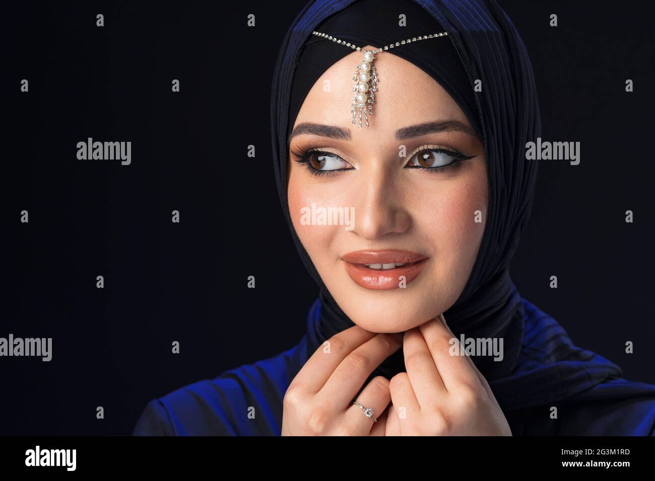 Portrait of a young muslim woman in hijab on black background Stock ...