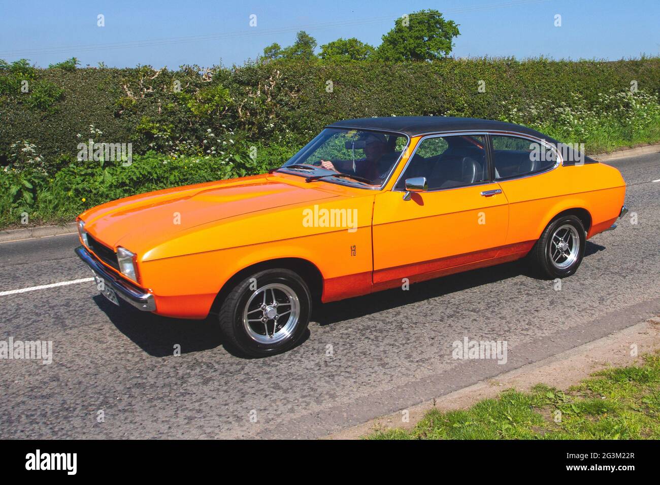 1976 70s seventies Orange British Ford Capri li 1300L 1298cc petrol 2dr coupe en-route to Capesthorne Hall classic May car show, Cheshire, UK Stock Photo