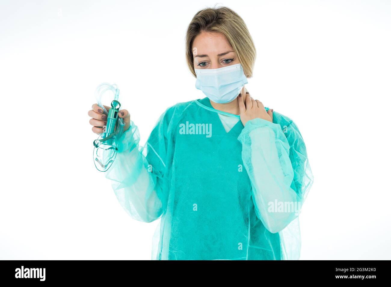 Portrait of exhausted Doctor in protective face mask holding non- invasive ventilator. Emotional stress of the front line health care workers, COVID-1 Stock Photo