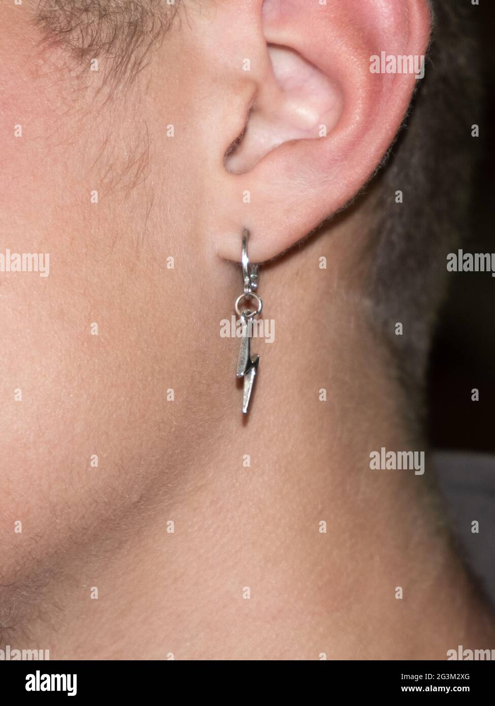 earring in a guy ear piercing culture Stock Photo Alamy