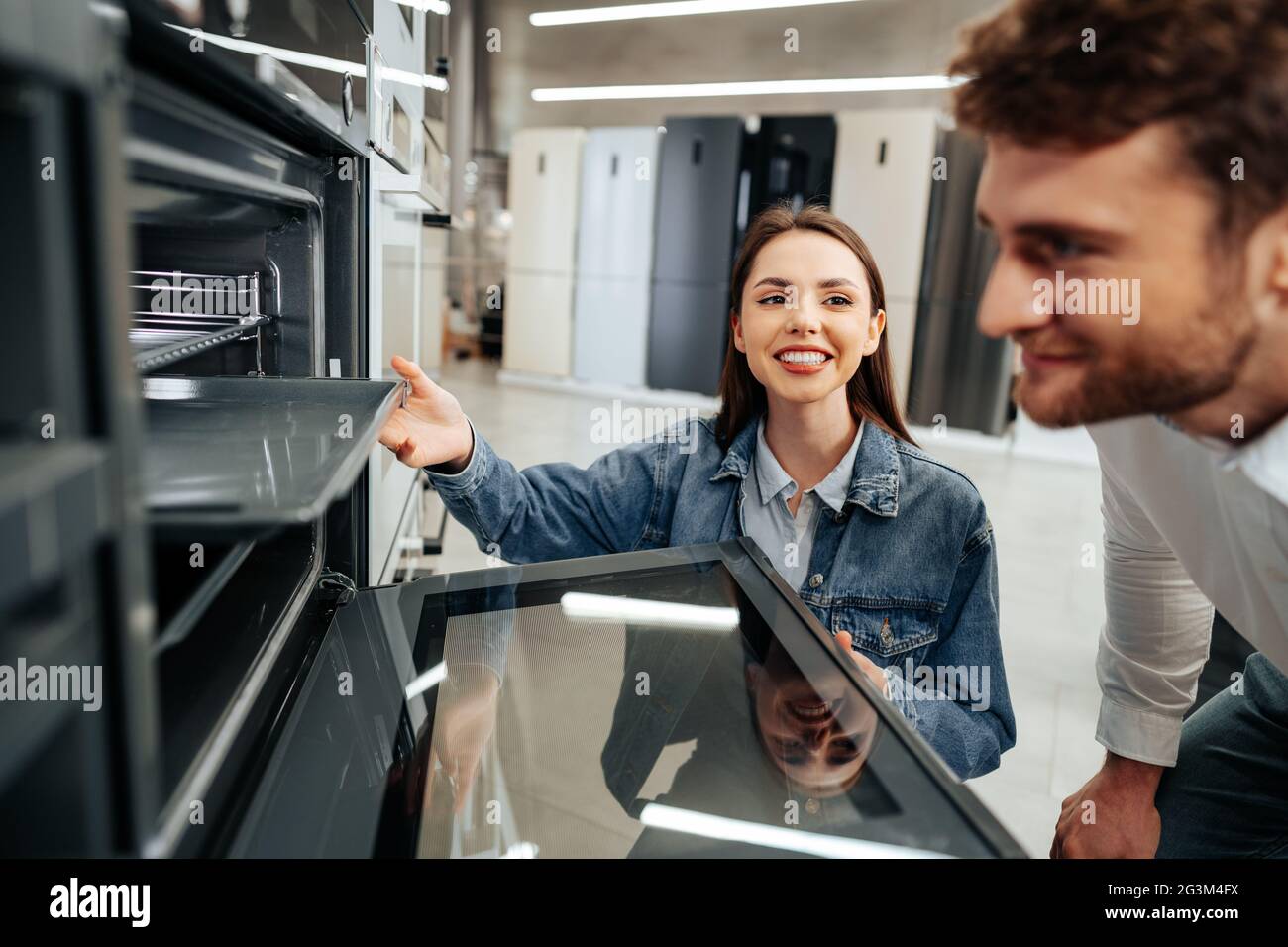 Young couple choosing new electric oven in hypermarket Stock Photo Alamy