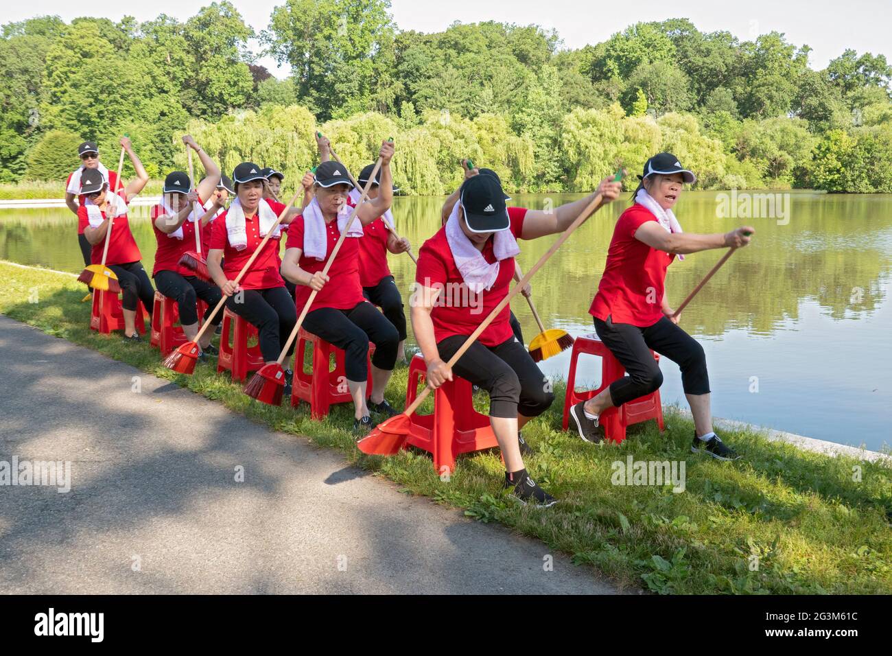 Middle age Chinese American dancer performing artists rehearse a rowing routine at a park in Flushing, Queens, New York City Stock Photo