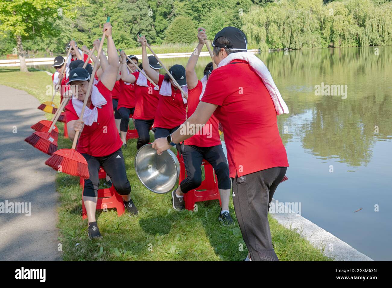 Middle age Chinese American dancer performing artists rehearse a rowing routine at a park in Flushing, Queens, New York City Stock Photo