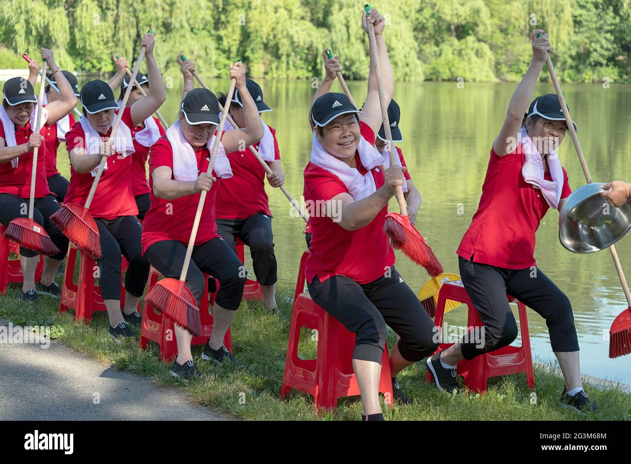 Middle age Chinese American dancer performing artists rehearse a rowing routine at a park in Flushing, Queens, New York City Stock Photo