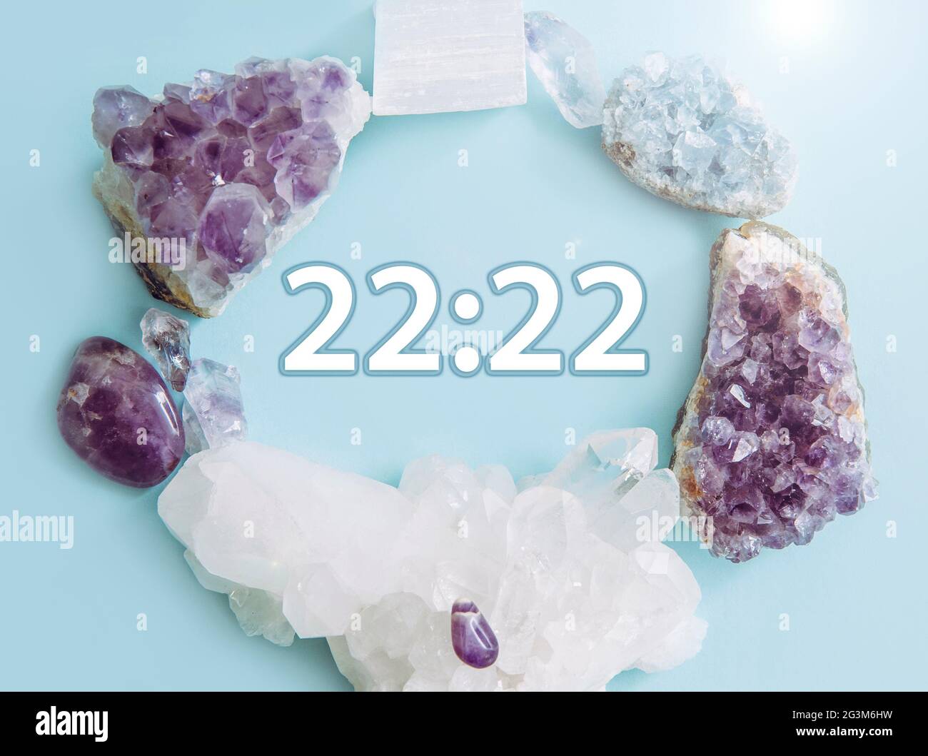 Seeing similar numbers 22:22 on clock. Seeing same similar numbers is called Angel numbers. Angels sending cryptic messages and communicating concept. Stock Photo