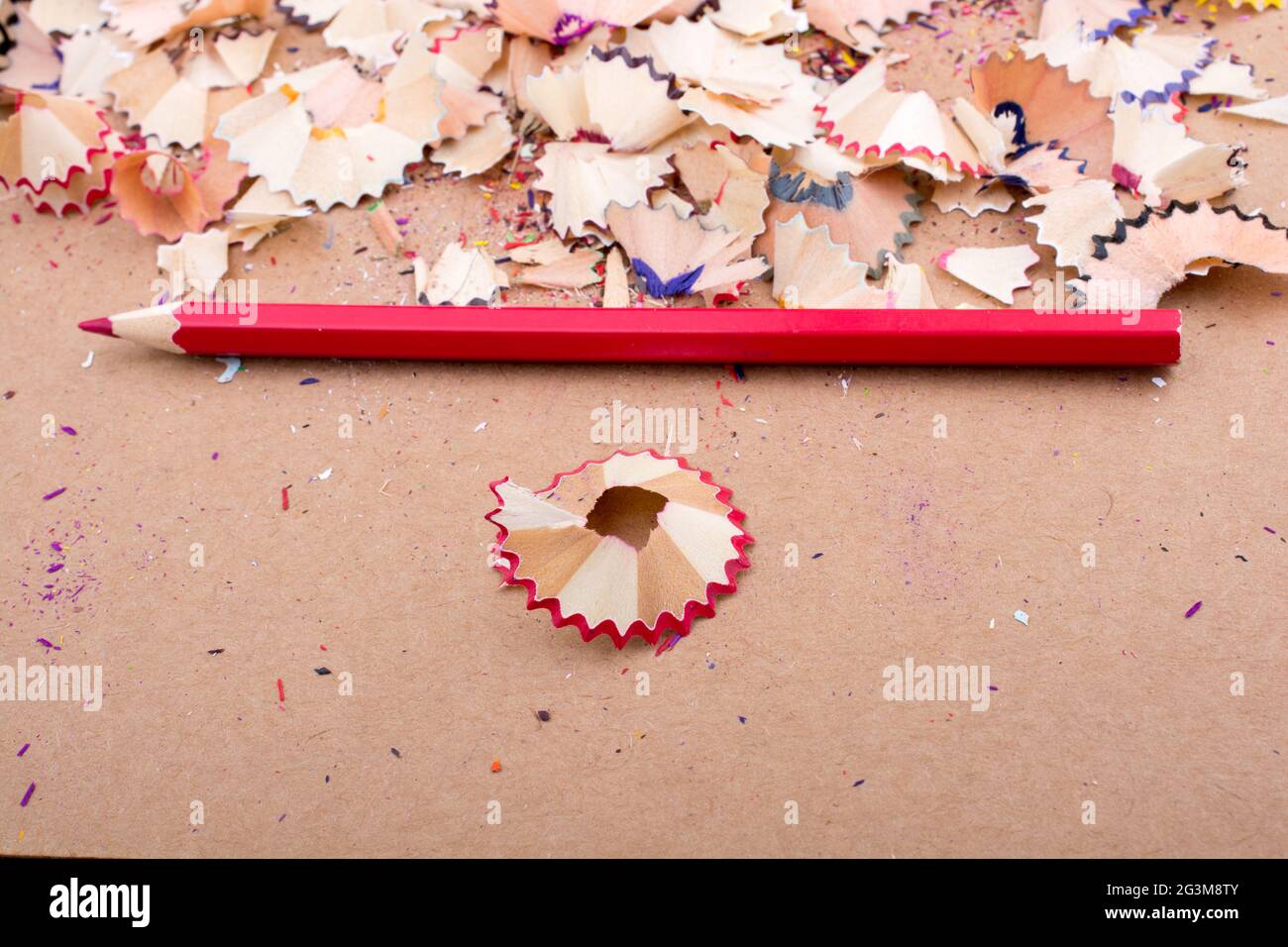 Red Color Pencil over some  pencil shavings Stock Photo